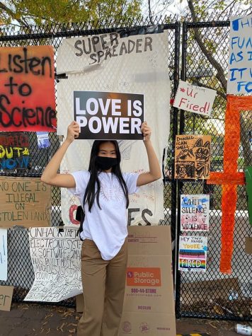 Theresa Le holding a sign celebrating love while in Washington DC
